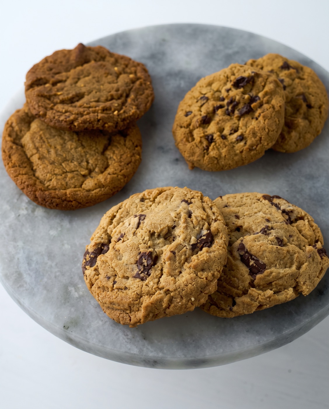Chocolate chunk and peanut butter cookies on a marble stand