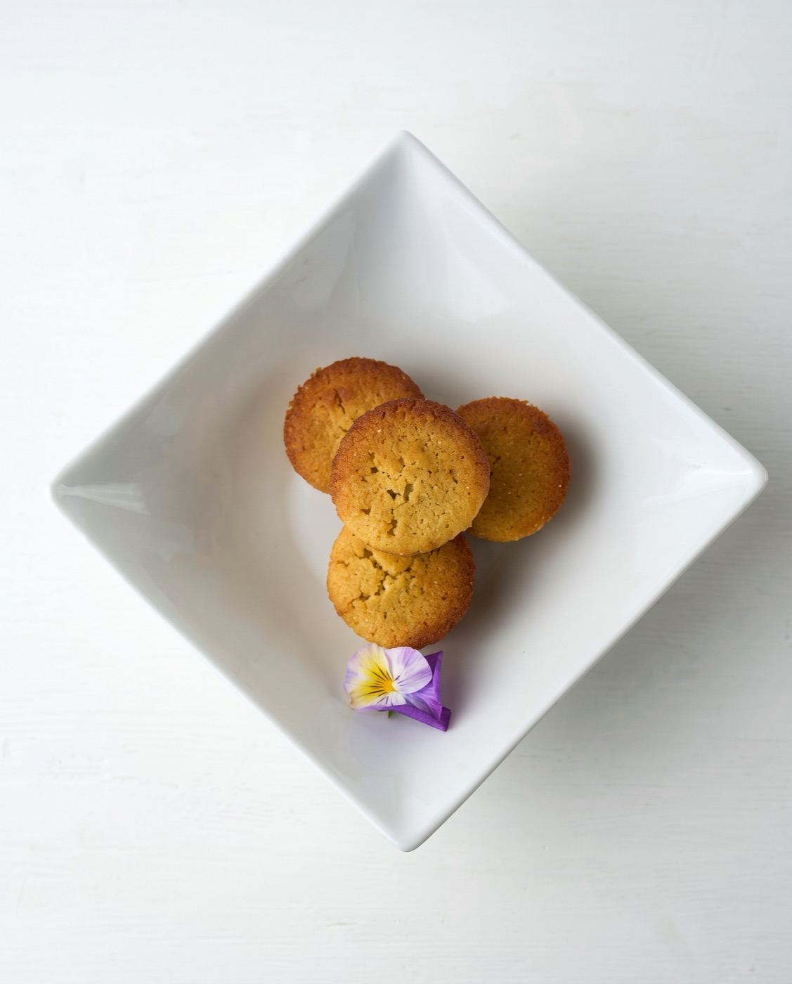 Almond blueberry frangipane cakes on a white dish