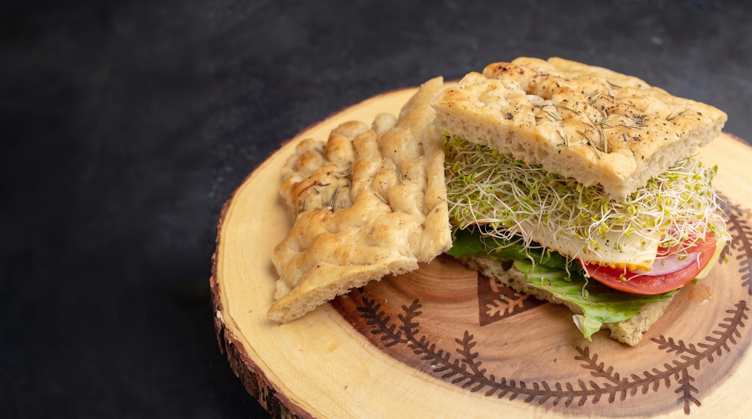 A lemon herb chicken focaccia sandwich cut in half